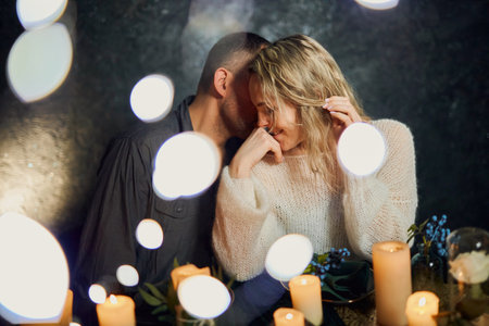 Romantic Candlelit Dinner Whisper in night restaurantの写真素材