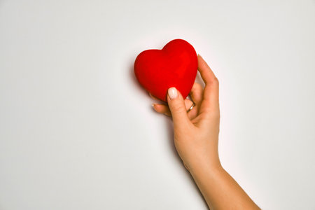 hands holding red heart, health care, love, organ donation, praying conceptの写真素材