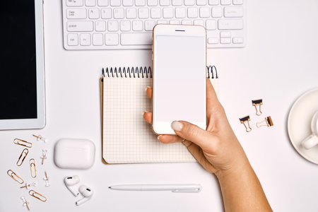 Freelance Feminine workspace with smartphoneの写真素材