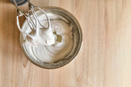 Whipped egg whites and other ingredients for creamの写真素材