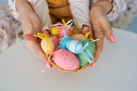 Selective focus on multicolor and design Easter Eggs on the hand.の写真素材
