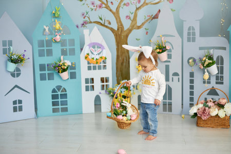 Funny cute girl in bunny ears celebrating Easterの写真素材