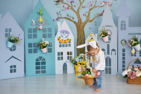 Funny cute girl in bunny ears celebrating Easterの写真素材
