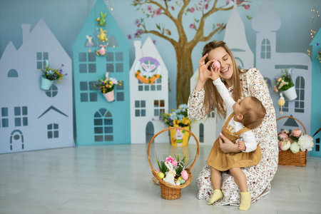 Mother and her daughter with painting eggs..の写真素材