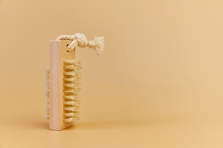 wooden massage brush with natural bristles on beige backgroundの写真素材