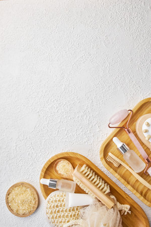 Spa and bathroom accessories on wooden tray, brush, oil, creamの写真素材
