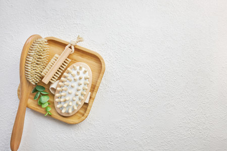 Massage bath set of bamboo brushes on a wooden trayの写真素材