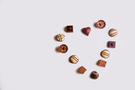 Heart shape made with various types of chocolate trufflesの写真素材