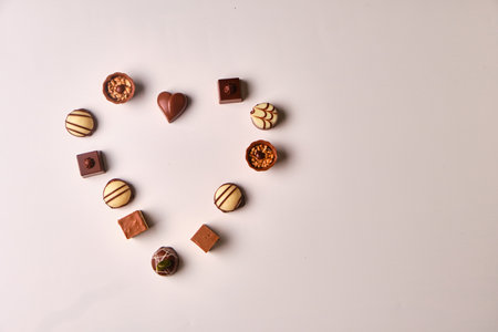 Heart shape made with various types of chocolate trufflesの写真素材