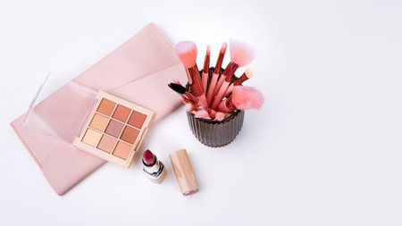 Set of decorative cosmetics on a white table, brushes, eye shadow and lipstick. Decorative cosmetics on dressing table in makeup roomの写真素材
