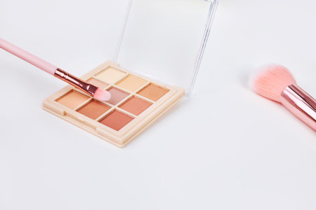 Widescreen background with Set of decorative cosmetics on a white table, brushes and eye shadow. Decorative cosmetics on dressing table in makeup roomの写真素材