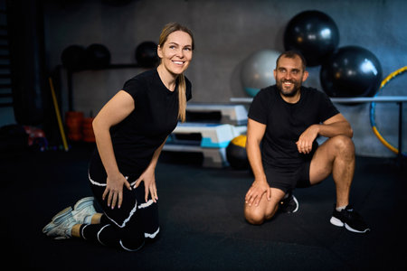 Two middle-aged athletes male and female after the training session in fitness.の写真素材