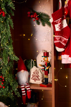cozy festive shelf adorned with classic Christmas decorations including a charming nutcracker, a...
