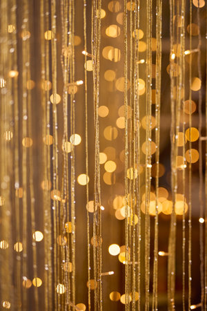 sparkling, vibrant background featuring warm golden bokeh lights and delicate shimmering threads,...