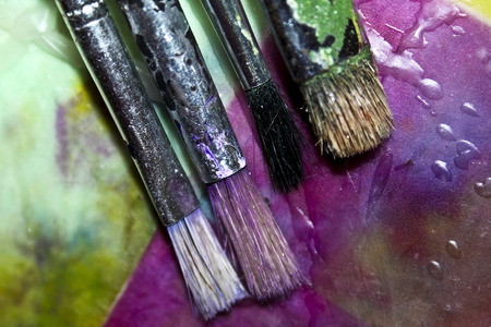 Painting brushes on a wax painting.の写真素材