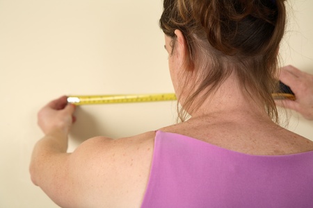 Young woman using a measurement tapeの写真素材