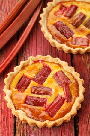 saffron cream tart on a red wooden backgroundの写真素材