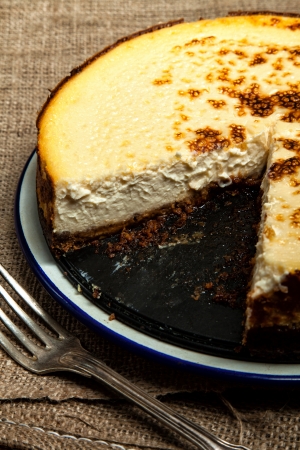 Homemade New York cheesecake with a slice missingの写真素材