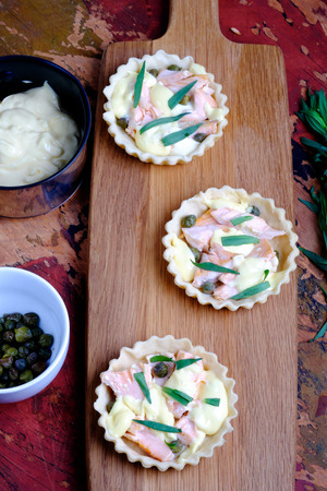 Salmon and hollandaise mini tarts with capers and tarragon の写真素材