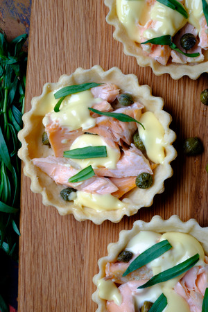 Salmon and hollandaise mini tarts with capers and tarragon の写真素材