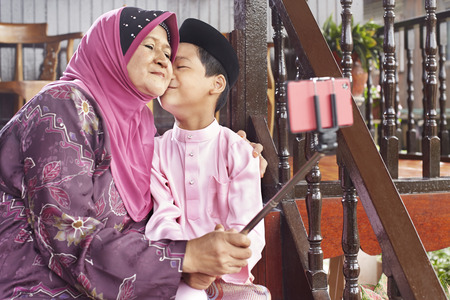 Grandmother taking selfie with her grandsonの写真素材