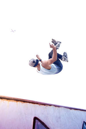 Young man doing inline skating tricks at a skate parkの写真素材