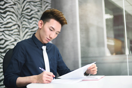 Businessman reviewing paper work in meeting room