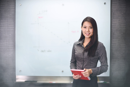 Smiling businesswoman holding notebook