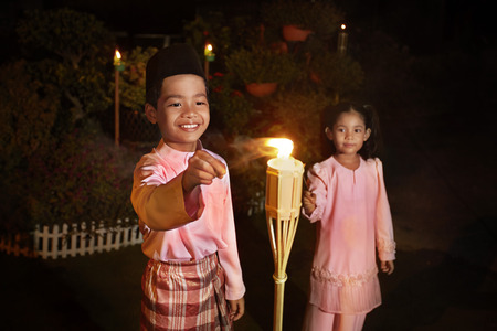 Kids play with sparklers on Hari Rayaの写真素材