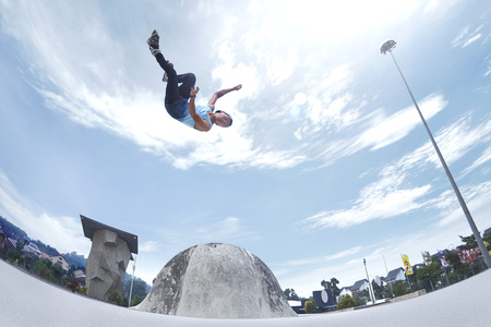 Young man doing inline skating tricks at a skate park