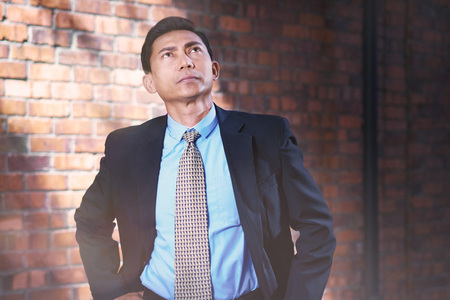 Businessman with serious expressions looking upの写真素材
