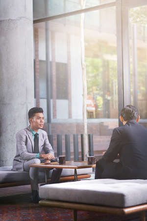 Businessmen having discussion in officeの写真素材