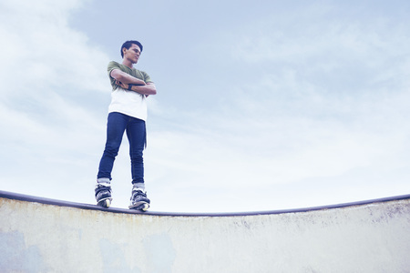 Portrait of confident young man at a skate parkの写真素材