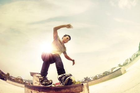 Young man inline skating at a skate parkの写真素材