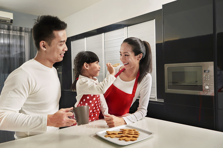 Family baking together in kitchenの写真素材