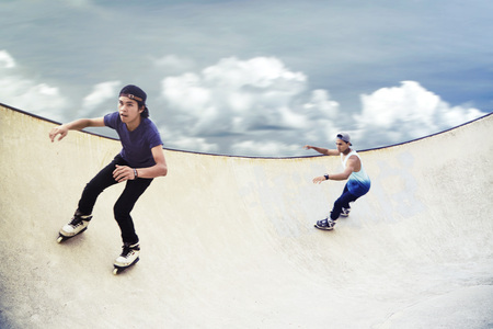 Young men inline skating at a skate park