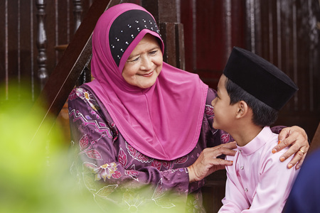 Grandmother sitting on porch steps with her grandsonの写真素材