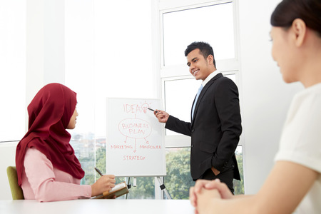 Business people in meeting room having discussionの写真素材