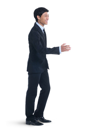 Young businessman extending hand to shake handsの写真素材