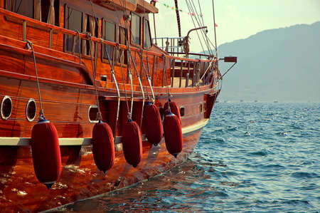 Luxury Yacht's Board with Mountains in the Background