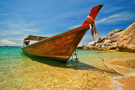 Longtail boat anchored at a beachの写真素材