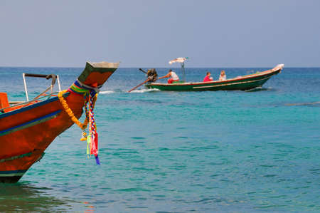 Thai genuine motorboat with tourist in the backgroundの写真素材