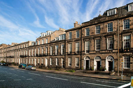 An old street with parked cars in Edinburghの写真素材