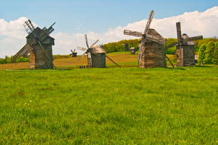 Vintage wind Mills in a green meadow.の写真素材