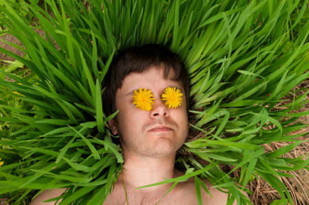 Man with Grass like Hairs and Dandelions in the eyesの写真素材