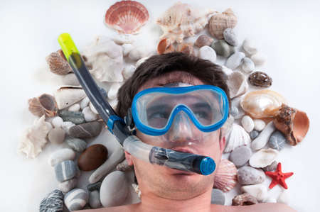 Man with a snorkel and diving mask dreaming of summer vacationの写真素材