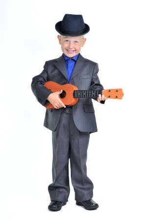 Smart Happy Boy in a Suit playing Guitarの写真素材