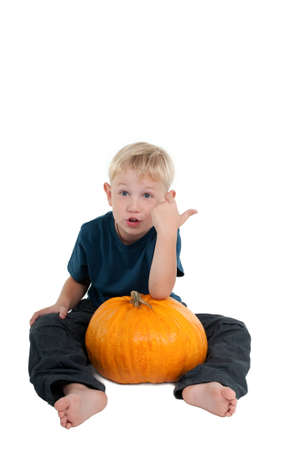 Young boy holding a pumpkinの写真素材