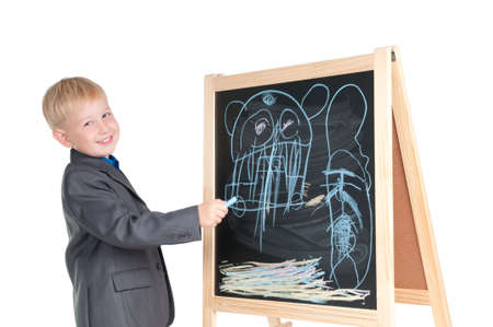 Smiling boy showing the drawing he made on a blackboardの写真素材