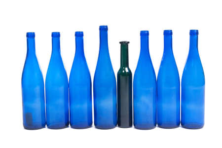 Blue wine bottles and a green one in between, isolated on white background の写真素材